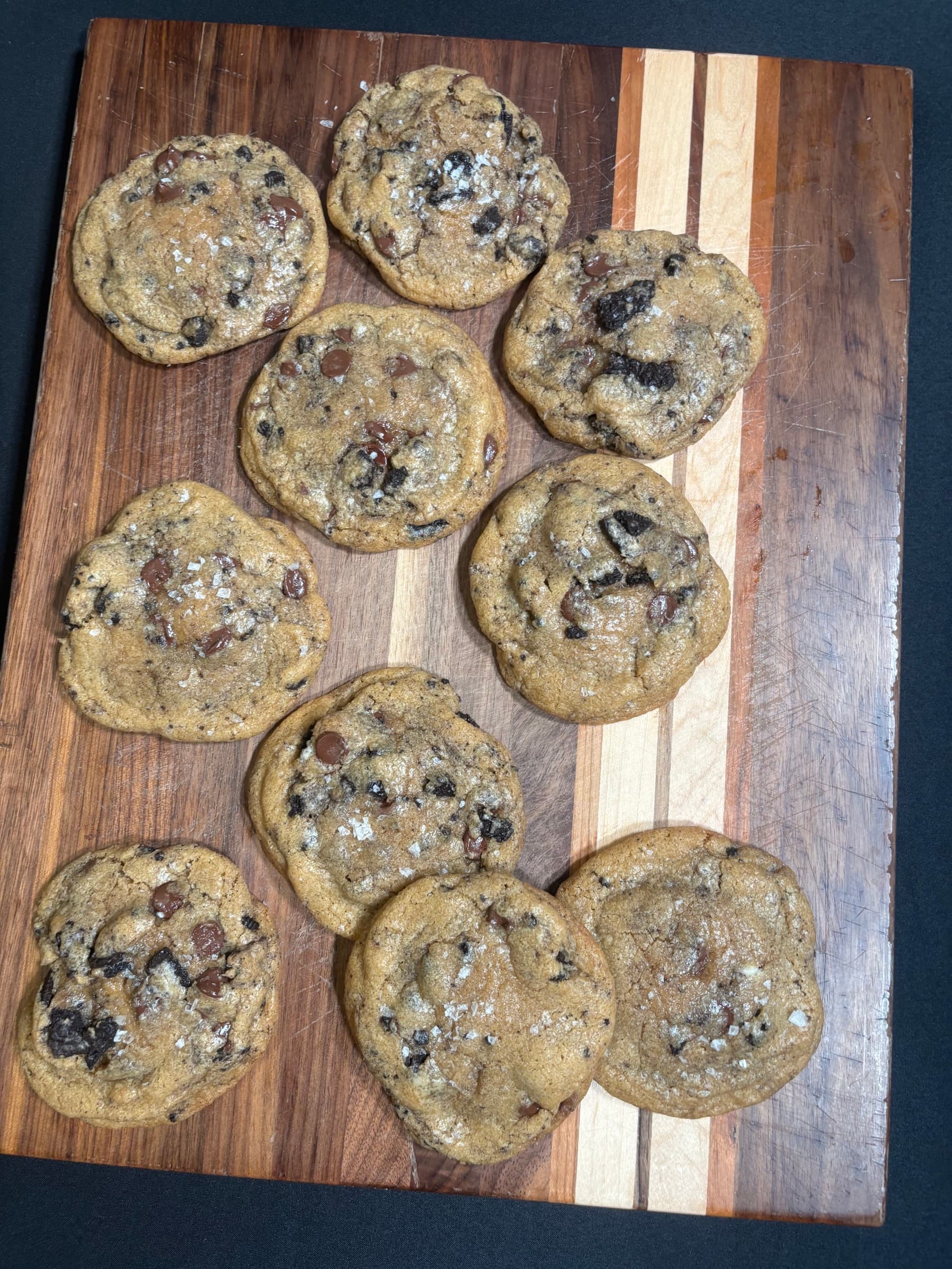 Fresh chocolate chip cookies with sea salt on a wooden board